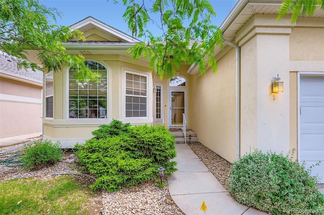 property entrance with stucco siding