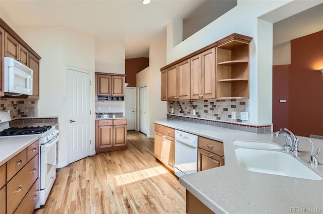 kitchen featuring white appliances, light wood finished floors, tasteful backsplash, open shelves, and light countertops