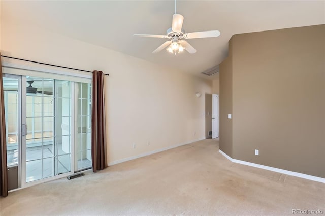 empty room featuring light colored carpet, ceiling fan, and vaulted ceiling