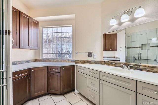 bathroom with vanity, tile patterned flooring, and a shower