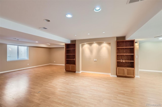 below grade area with light wood-type flooring, built in features, and recessed lighting