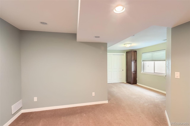 unfurnished room featuring light colored carpet