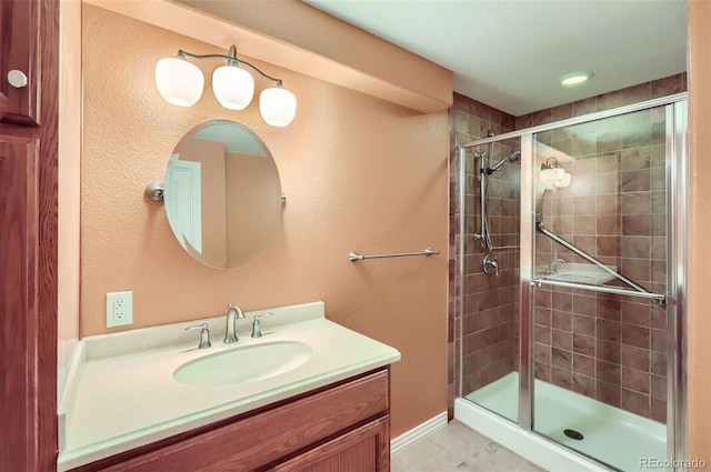 full bath featuring vanity, a shower stall, and tile patterned flooring