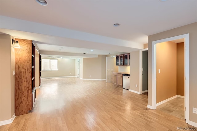 unfurnished living room featuring bar area, light wood-style flooring, and recessed lighting