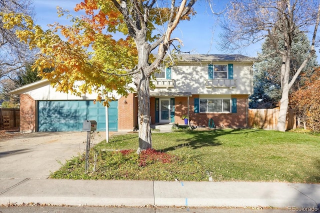 view of front of home with a front yard and a garage