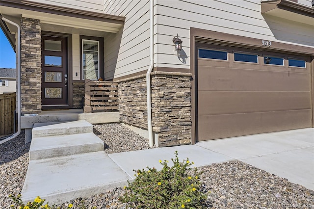 view of exterior entry with a garage