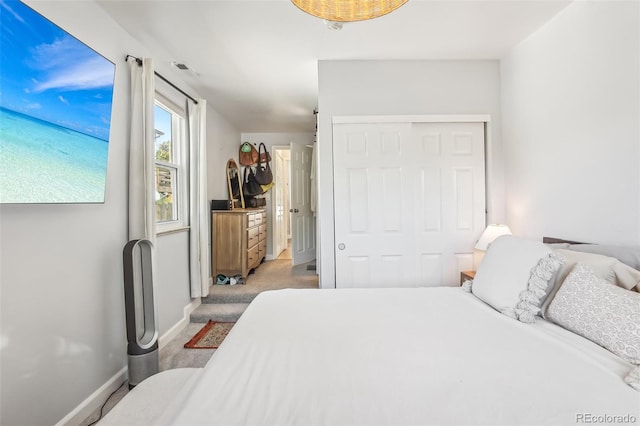 carpeted bedroom with a closet