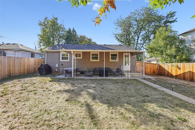 rear view of property with a patio area and a lawn