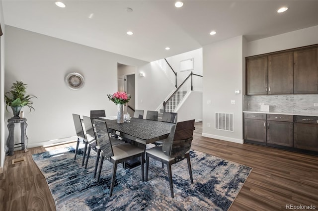 dining area with dark wood finished floors, recessed lighting, baseboards, visible vents, and stairway