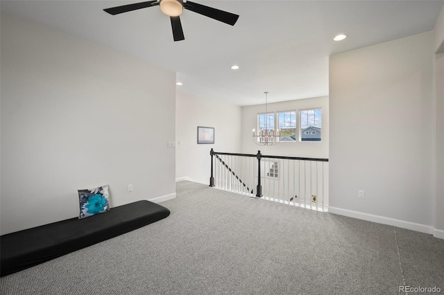 carpeted spare room with recessed lighting, baseboards, and ceiling fan with notable chandelier