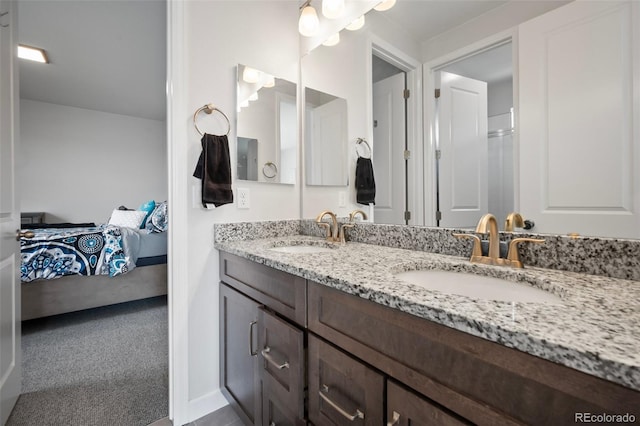 bathroom with ensuite bathroom, a sink, and double vanity