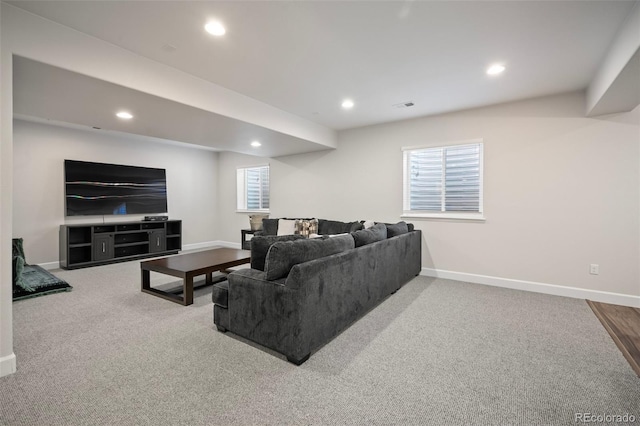 carpeted living room with recessed lighting and baseboards
