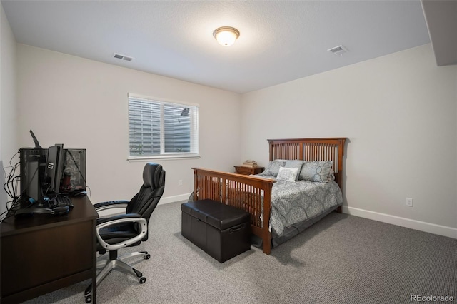 carpeted bedroom featuring baseboards and visible vents