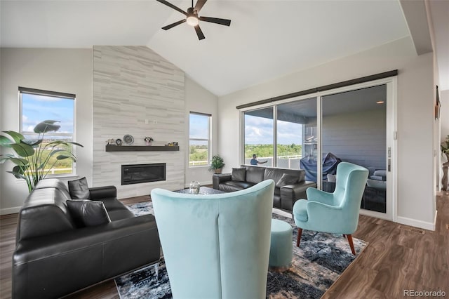 living room with a premium fireplace, high vaulted ceiling, a ceiling fan, baseboards, and wood finished floors