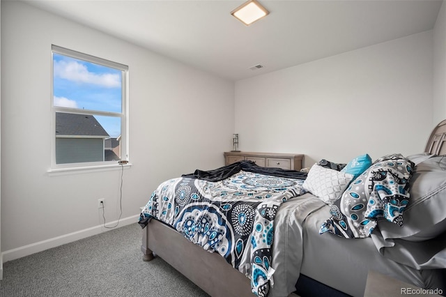 carpeted bedroom featuring baseboards and visible vents