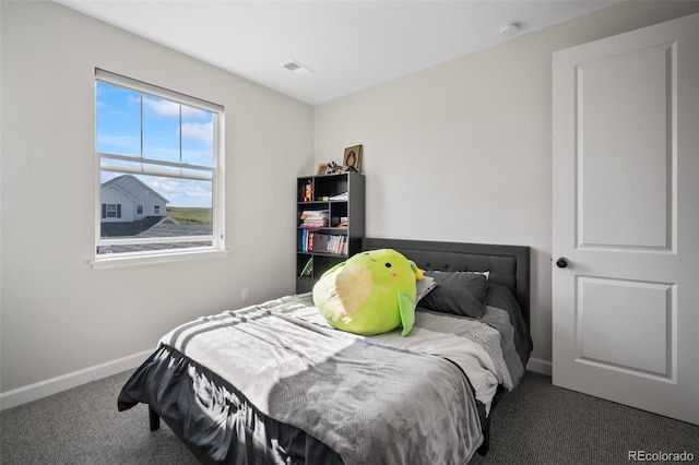 bedroom featuring baseboards, carpet flooring, and visible vents