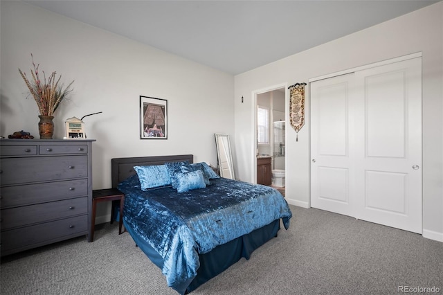 carpeted bedroom with baseboards, ensuite bathroom, and a closet