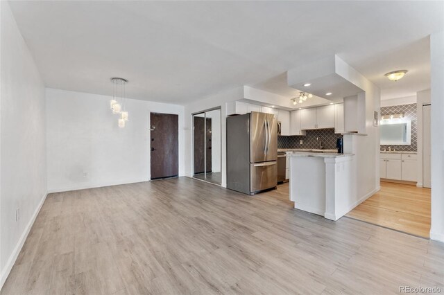 2 Adams St Unit 608, Denver, CO 80206 - kitchen with stainless steel appliances, light countertops, decorative backsplash, and light wood finished floors