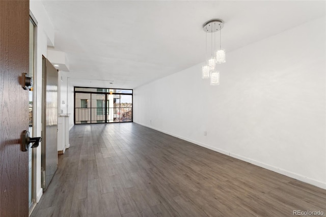 2 Adams St Unit 608, Denver, CO 80206 - unfurnished room with dark wood-type flooring, a chandelier, baseboards, and expansive windows
