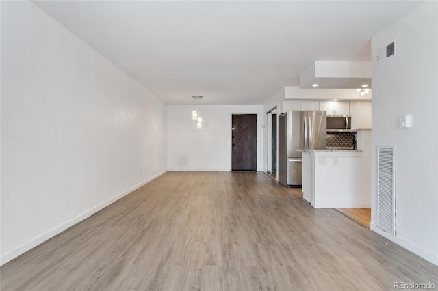 2 Adams St Unit 608, Denver, CO 80206 - unfurnished living room with light wood finished floors and baseboards