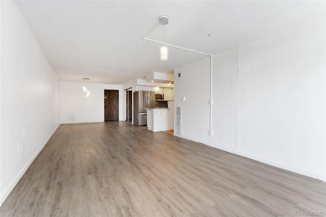 2 Adams St Unit 608, Denver, CO 80206 - unfurnished living room with light wood finished floors and baseboards