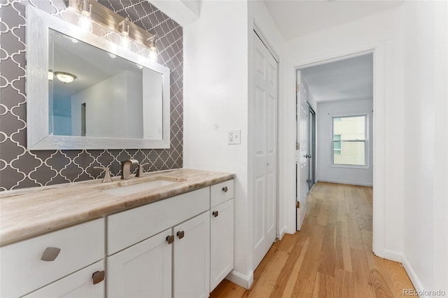 2 Adams St Unit 608, Denver, CO 80206 - bathroom with wood finished floors, vanity, and baseboards