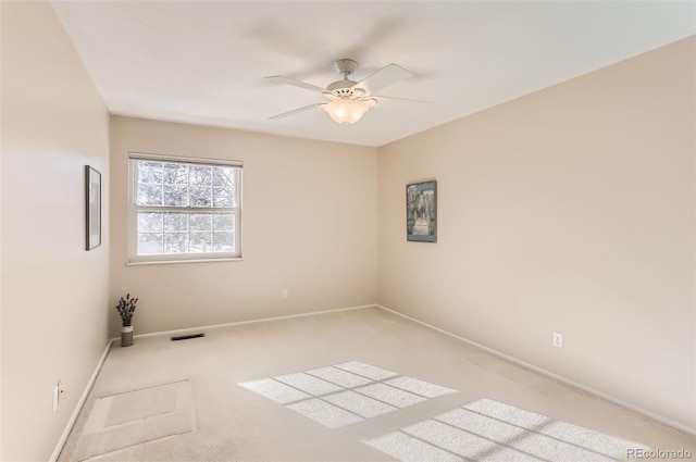 unfurnished room featuring light carpet and ceiling fan