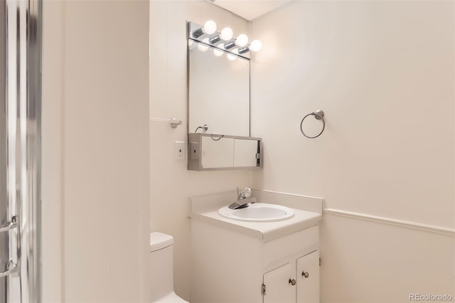 bathroom with vanity and toilet