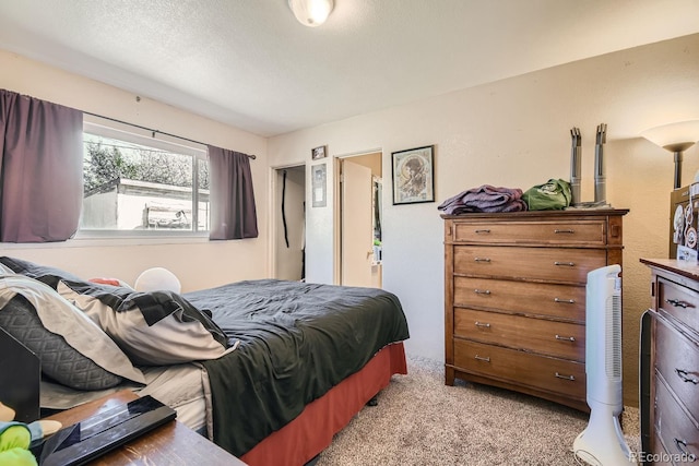 carpeted bedroom featuring a textured ceiling