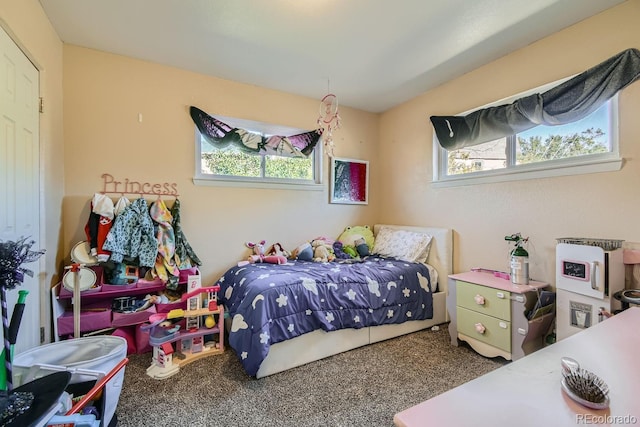 carpeted bedroom featuring multiple windows