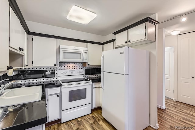 735 S Clinton St Unit 5B, Denver, CO 80247 - kitchen featuring white appliances, dark countertops, backsplash, and wood finished floors