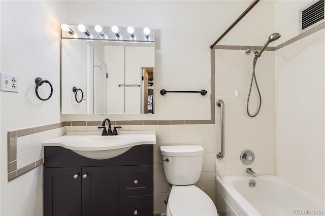 735 S Clinton St Unit 5B, Denver, CO 80247 - bathroom with vanity, tile walls, bathing tub / shower combination, and a wainscoted wall