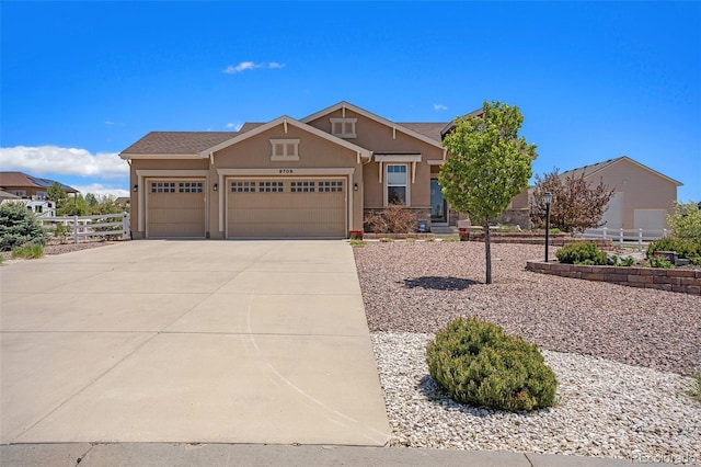 9709 Rockingham Dr, Peyton, CO 80831 - view of front of home featuring stucco siding, a garage, and concrete driveway