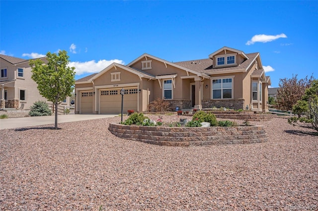 9709 Rockingham Dr, Peyton, CO 80831 - view of front of house with stucco siding, an attached garage, driveway, and stone siding
