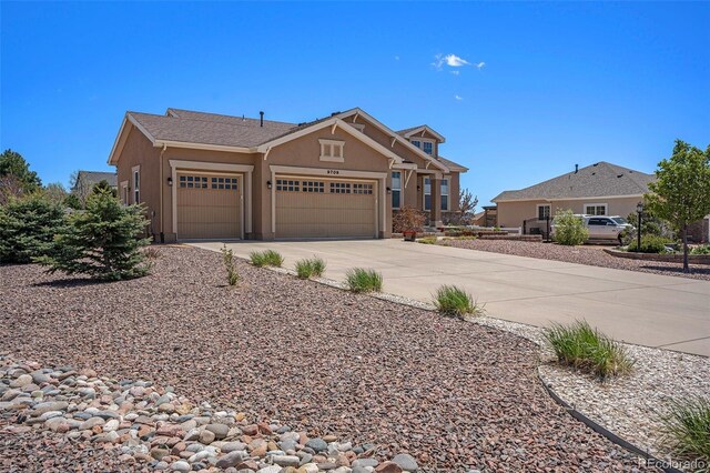 9709 Rockingham Dr, Peyton, CO 80831 - craftsman-style home with a garage, concrete driveway, and stucco siding