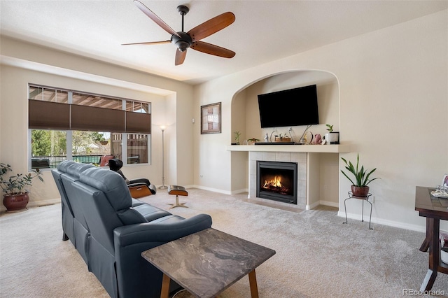 9709 Rockingham Dr, Peyton, CO 80831 - carpeted living room featuring a tiled fireplace, a ceiling fan, and baseboards