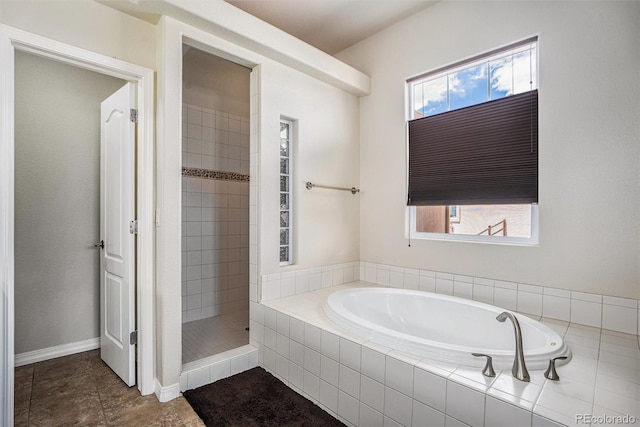 9709 Rockingham Dr, Peyton, CO 80831 - full bath with a bath, tiled shower, plenty of natural light, and tile patterned floors