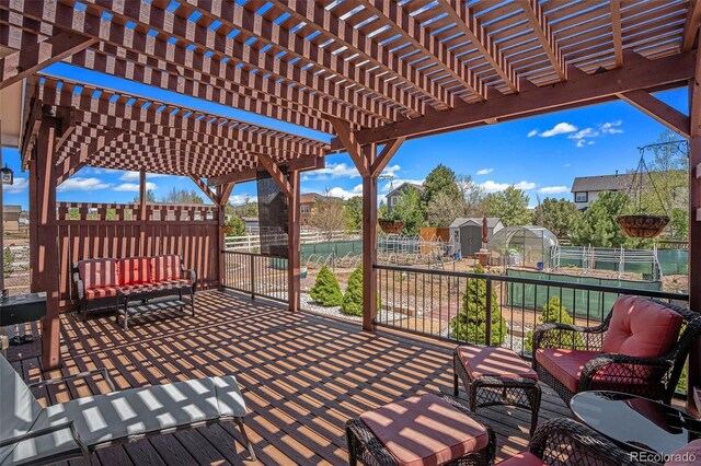 9709 Rockingham Dr, Peyton, CO 80831 - deck with a fenced backyard, an outdoor hangout area, and a pergola