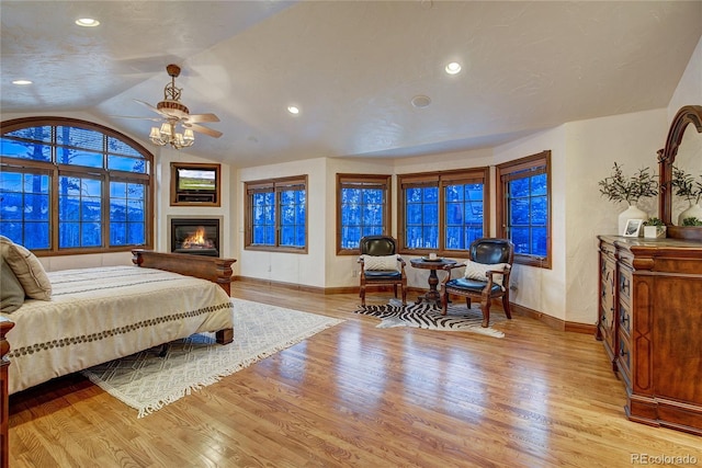 bedroom with lofted ceiling, light hardwood / wood-style flooring, and ceiling fan