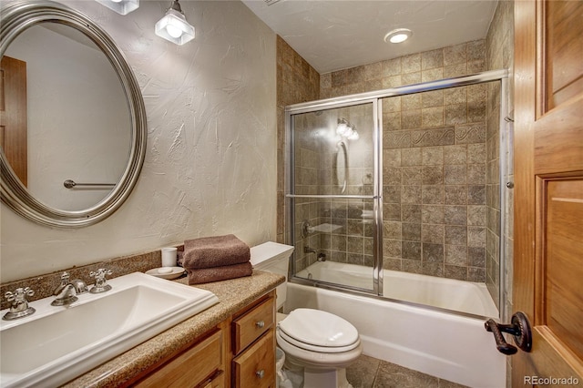 full bathroom featuring vanity, tile patterned floors, toilet, and combined bath / shower with glass door