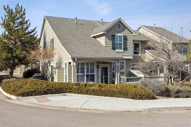 traditional home with roof with shingles