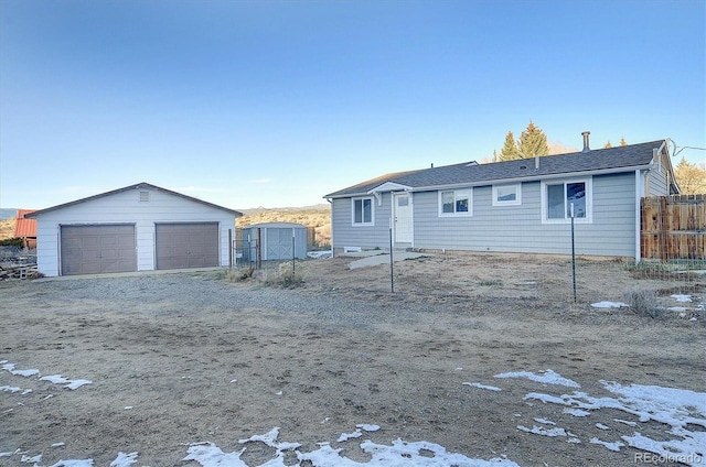 view of front of house with a shed and a garage