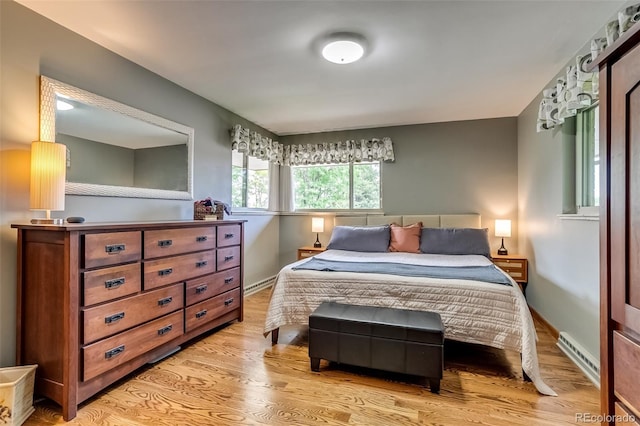 9650 W 35th Ave, Wheat Ridge, CO 80033 - bedroom featuring a baseboard heating unit and light wood finished floors