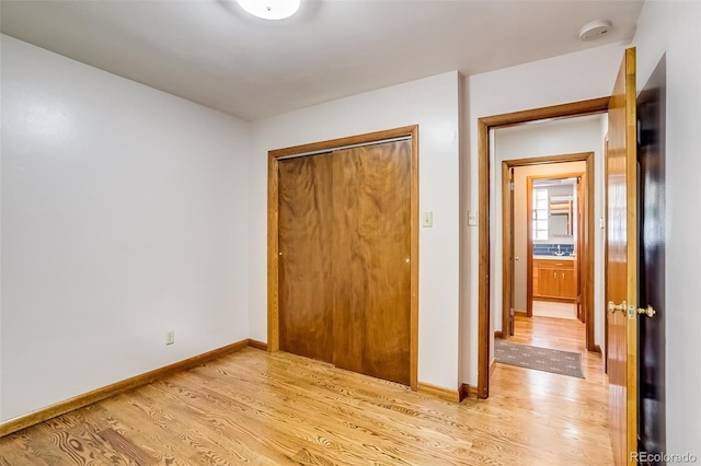 9650 W 35th Ave, Wheat Ridge, CO 80033 - unfurnished bedroom featuring light wood finished floors and a closet