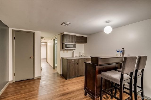 9650 W 35th Ave, Wheat Ridge, CO 80033 - indoor bar with stainless steel microwave, light wood finished floors, and decorative light fixtures