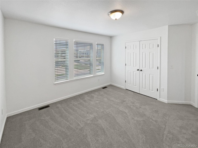 23559 Branston Ln, Parker, CO 80138 - unfurnished bedroom with baseboards, visible vents, carpet, and a closet