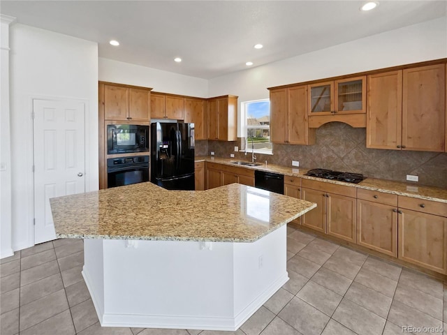 23559 Branston Ln, Parker, CO 80138 - kitchen with light stone countertops, a center island, light tile patterned floors, tasteful backsplash, and black appliances