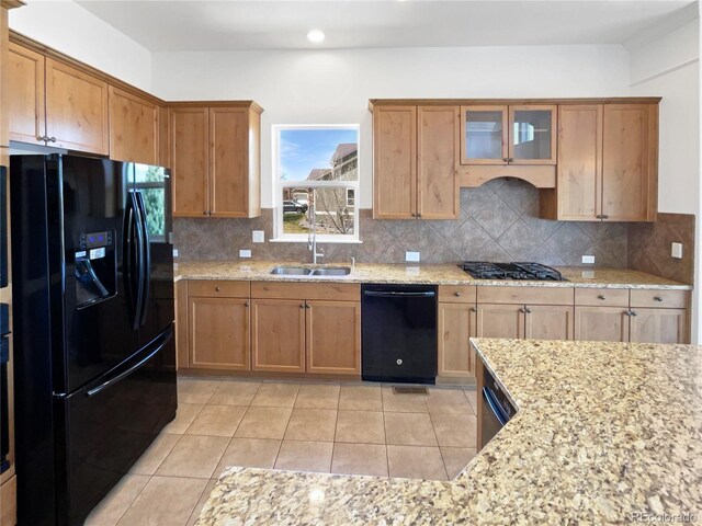 23559 Branston Ln, Parker, CO 80138 - kitchen featuring light stone counters, a sink, backsplash, and black appliances