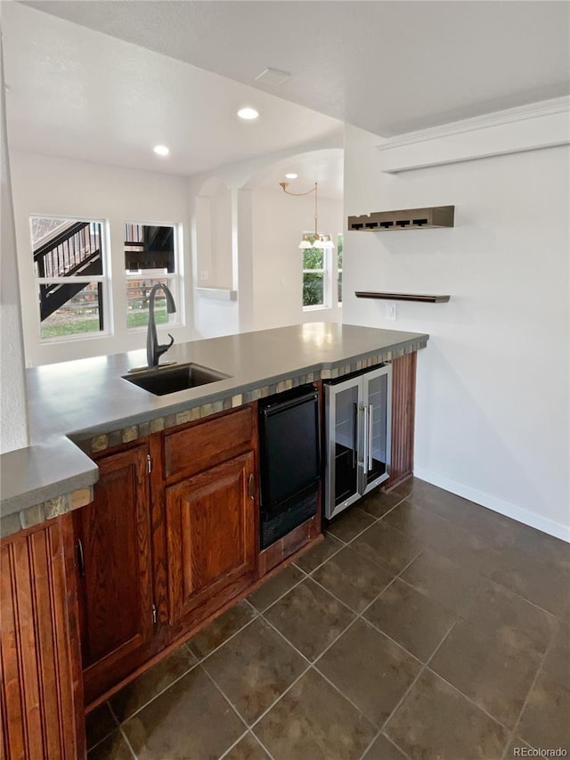 23559 Branston Ln, Parker, CO 80138 - bar featuring beverage cooler, a sink, a wealth of natural light, and dark tile patterned flooring