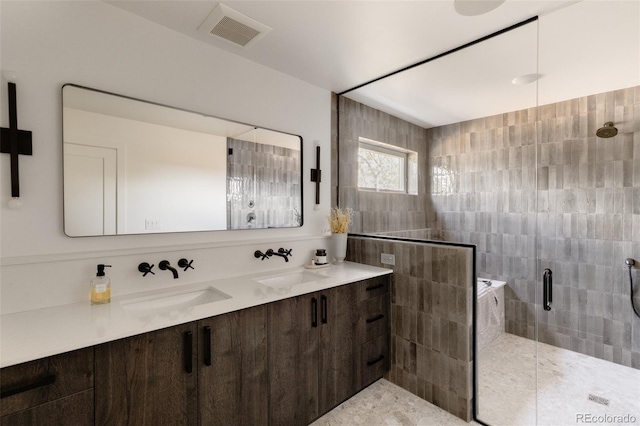 bathroom featuring vanity and a shower with door